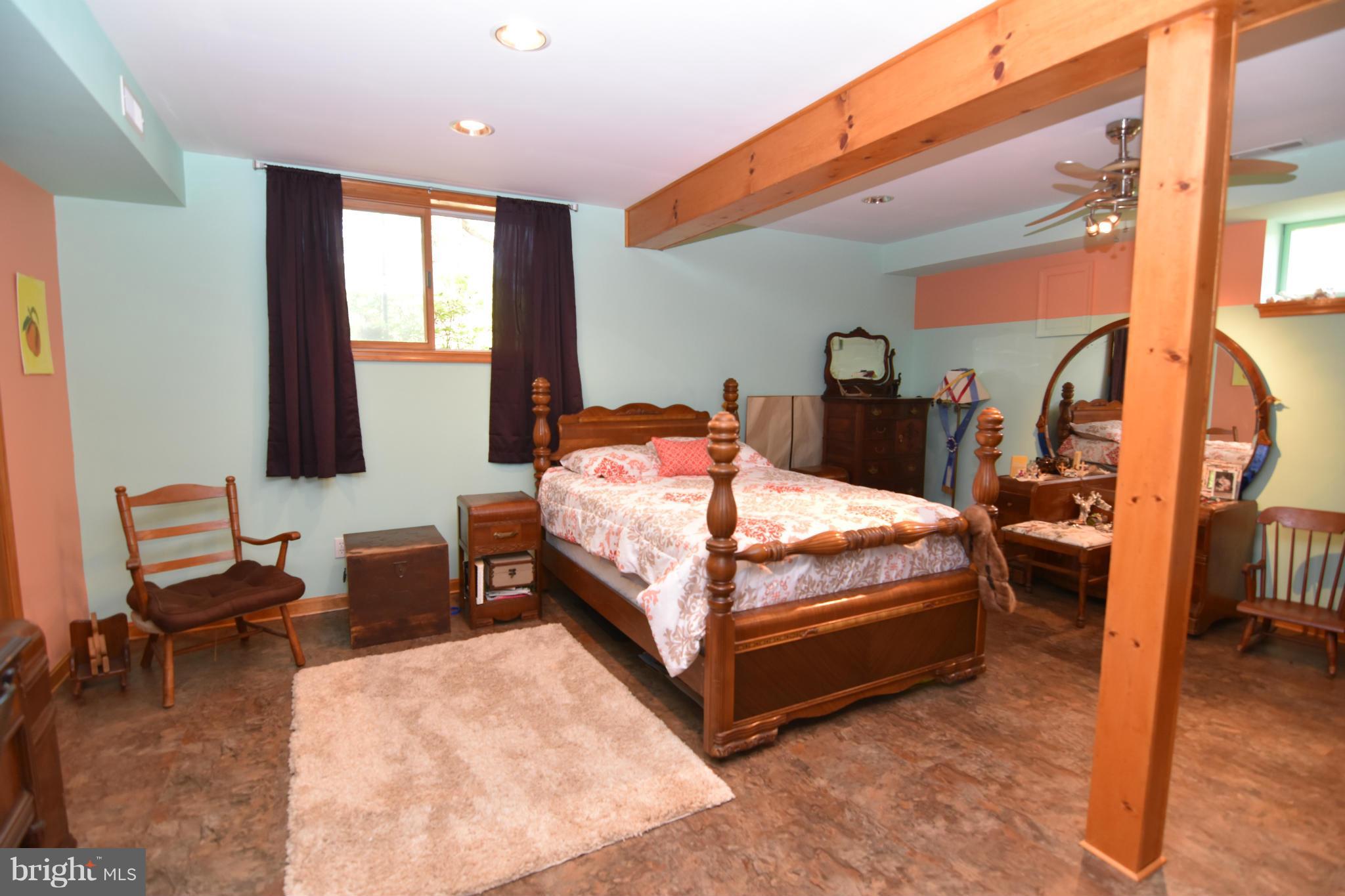 20510 Raceground Road Callaway, MD 20620 - Photo 14 of 30 a bedroom with a bed and wooden floor