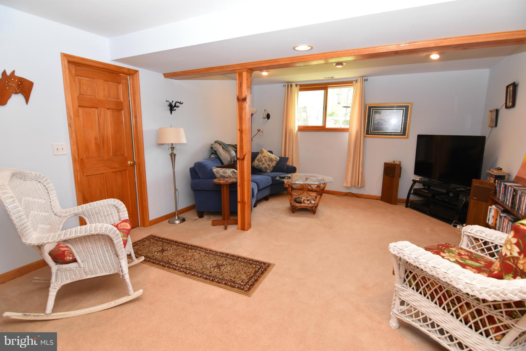20510 Raceground Road Callaway, MD 20620 - Photo 15 of 30 a living room with furniture a flat screen tv and a window