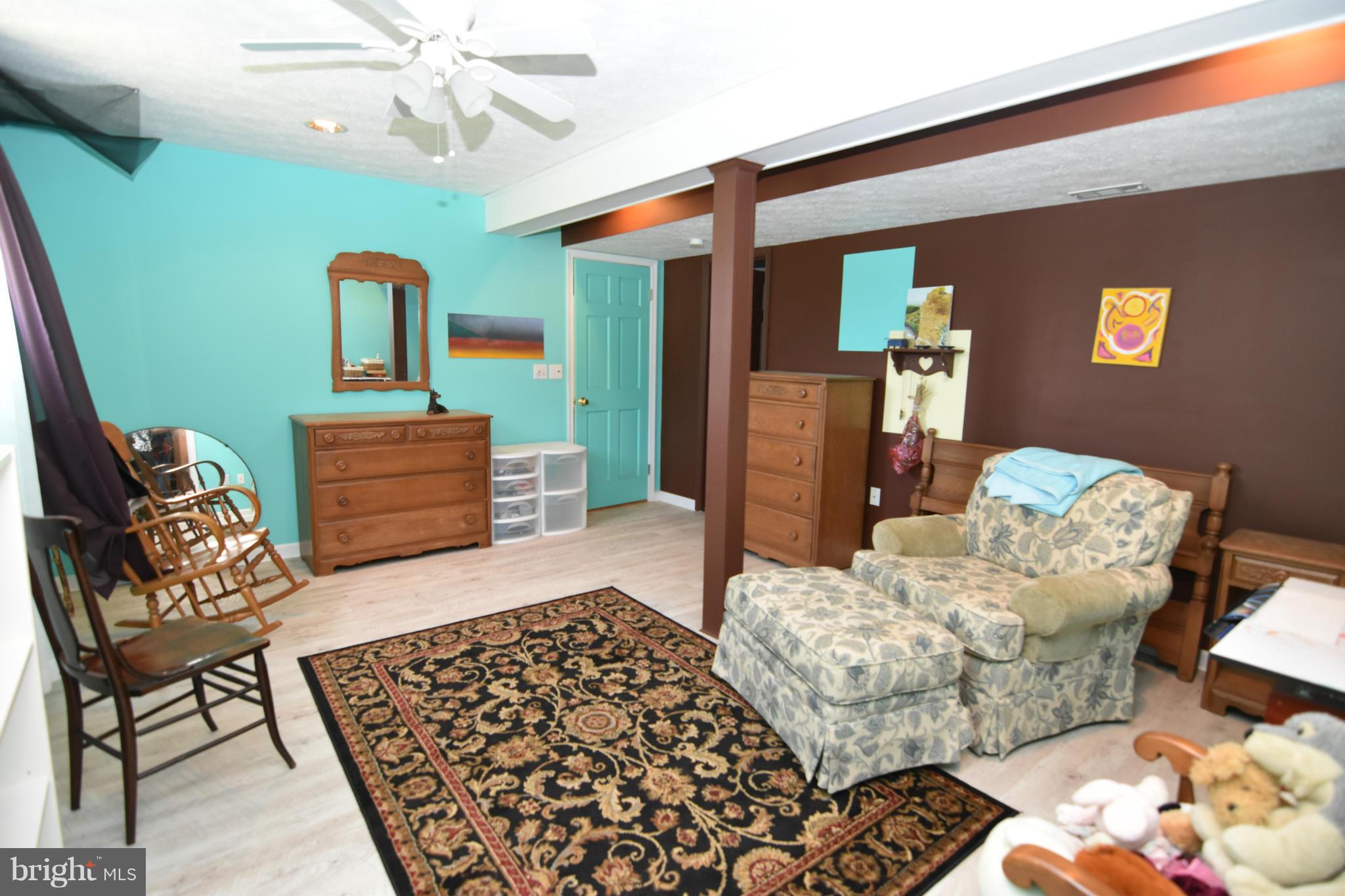 20510 Raceground Road Callaway, MD 20620 - Photo 16 of 30 a bedroom with furniture and wooden floor