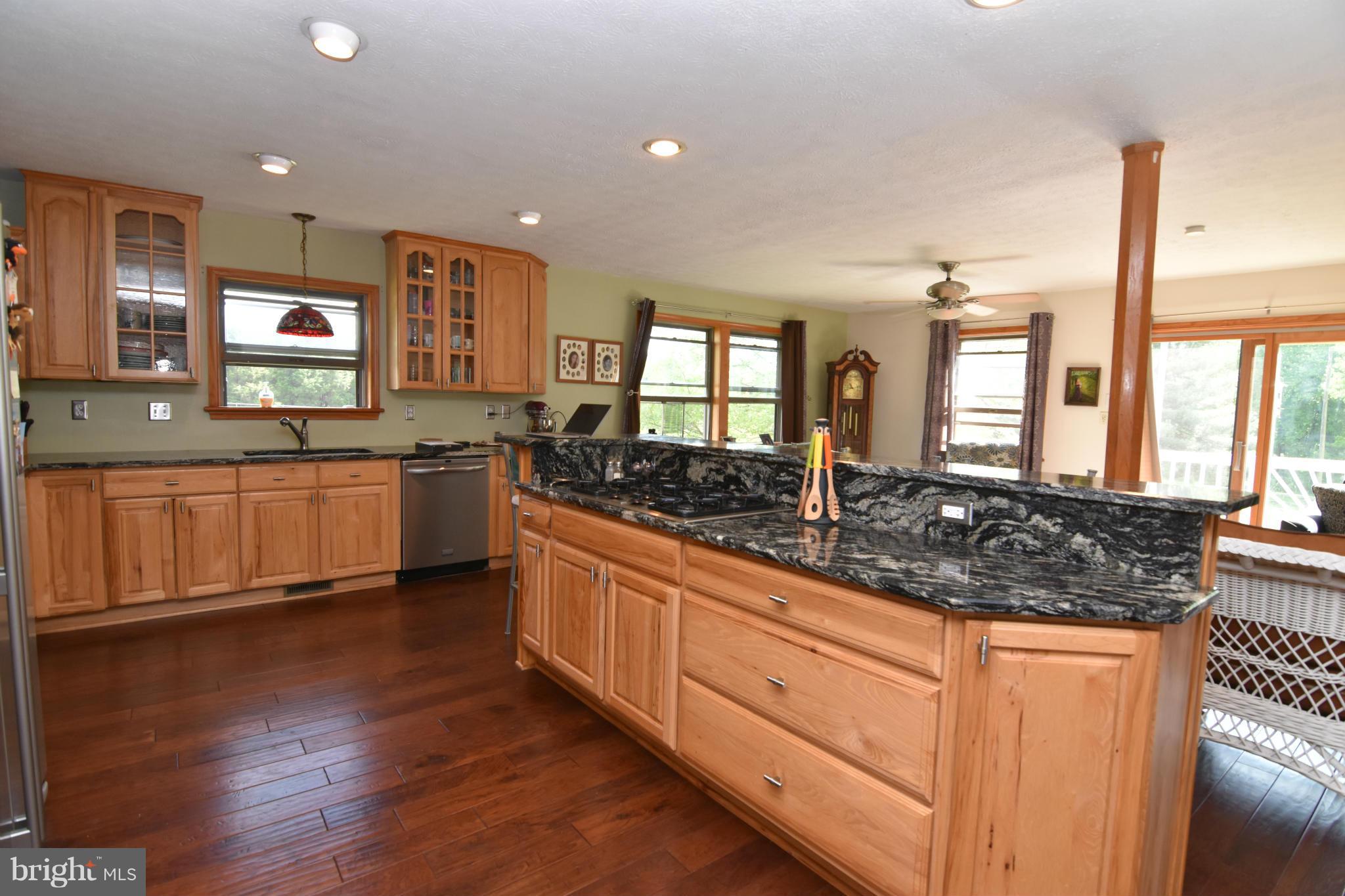 20510 Raceground Road Callaway, MD 20620 - Photo 4 of 30 a large kitchen with stainless steel appliances granite countertop a sink and a stove