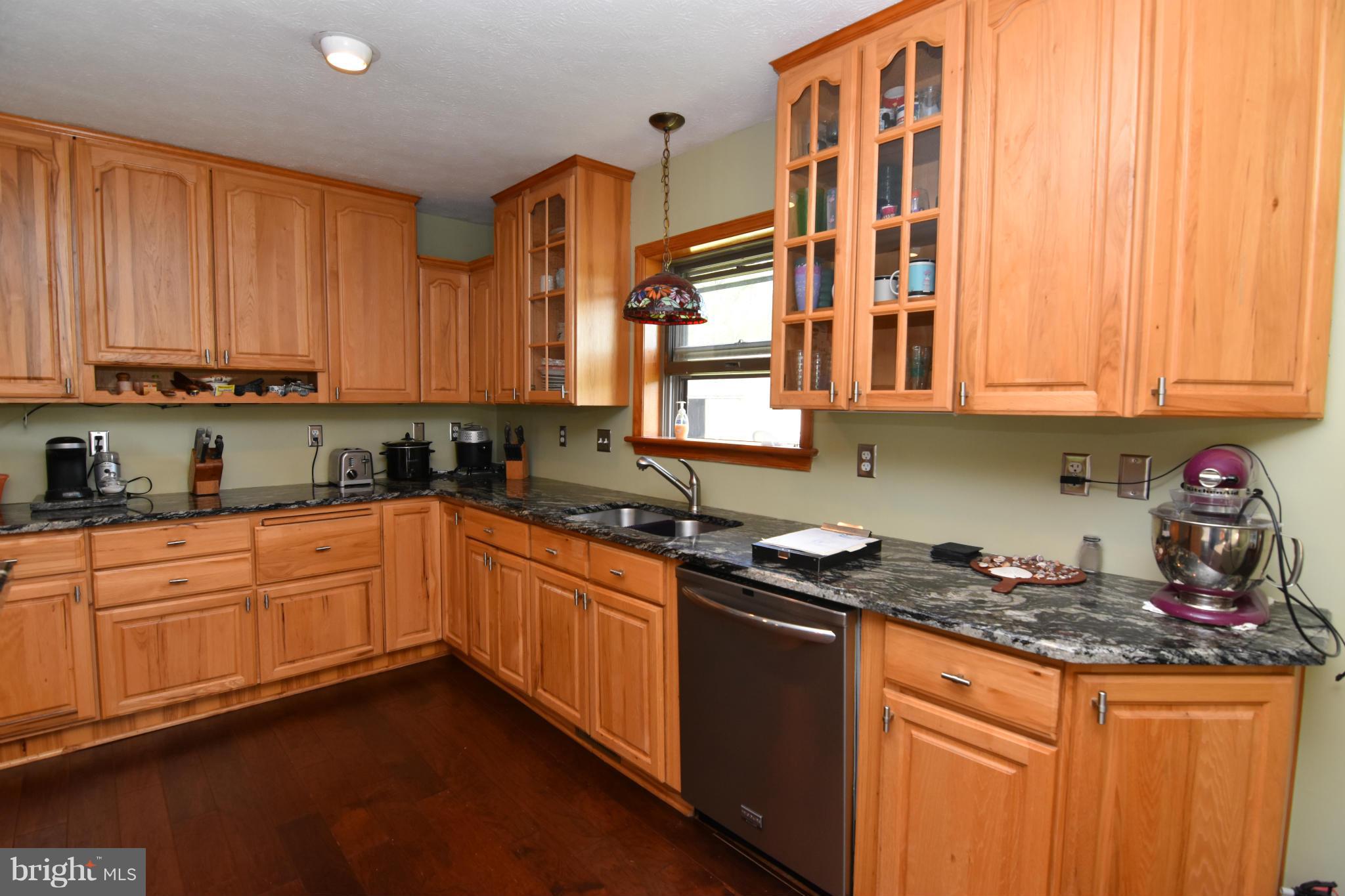 20510 Raceground Road Callaway, MD 20620 - Photo 6 of 30 a kitchen with stainless steel appliances granite countertop a stove a sink and a microwave