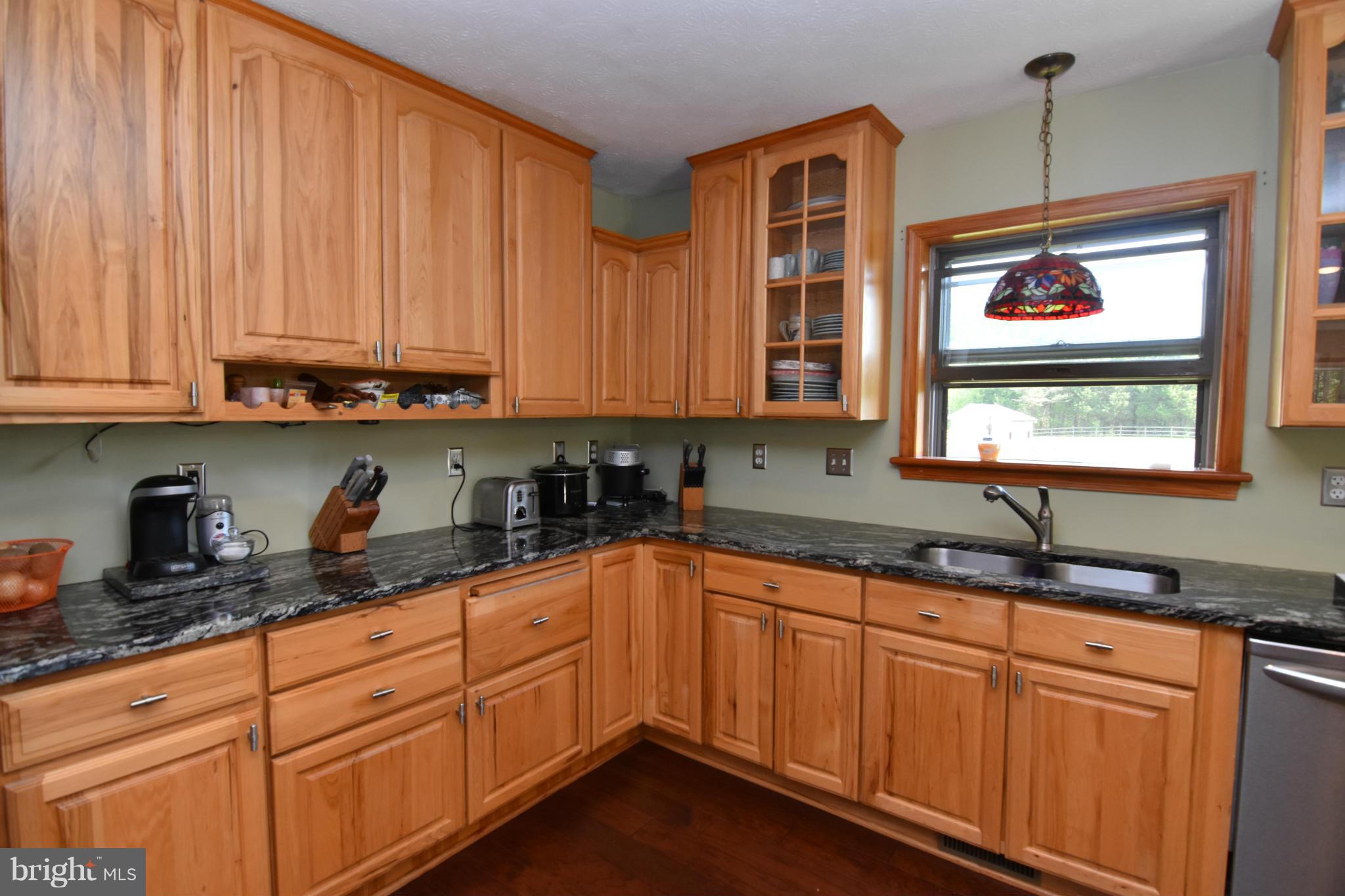 20510 Raceground Road Callaway, MD 20620 - Photo 7 of 30 a kitchen with granite countertop stainless steel appliances a sink window and cabinets