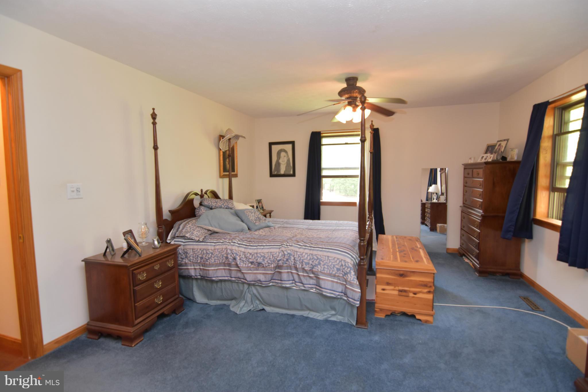 20510 Raceground Road Callaway, MD 20620 - Photo 9 of 30 a bedroom with bed and a chandelier