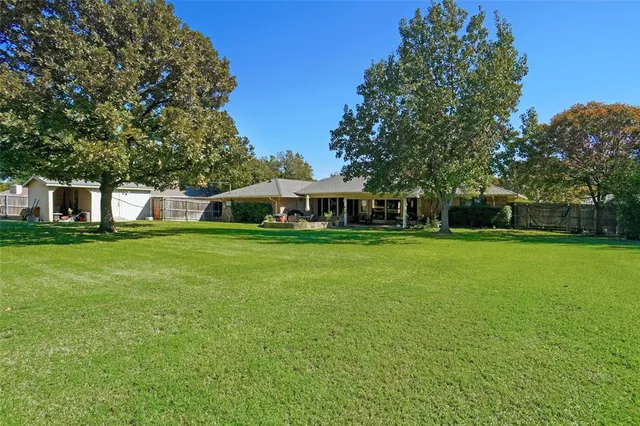 a view of a patio with a table chairs and a garden