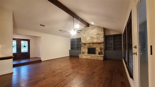 a spacious bedroom with a bed and dresser