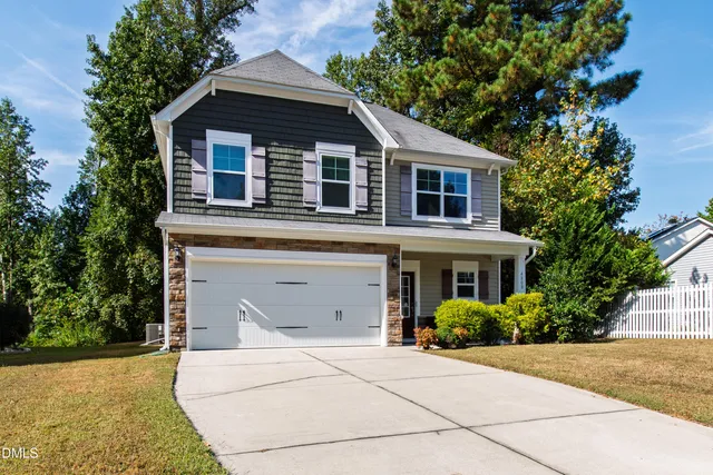 a front view of a house with garage