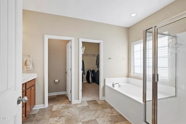 a bathroom with a bathtub and a shower