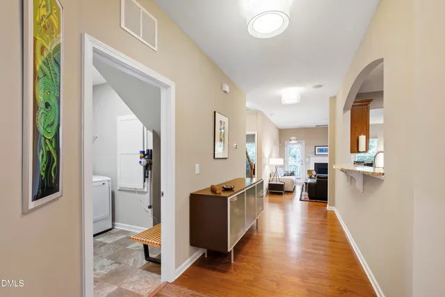 a view of a living room with furniture and wooden floor