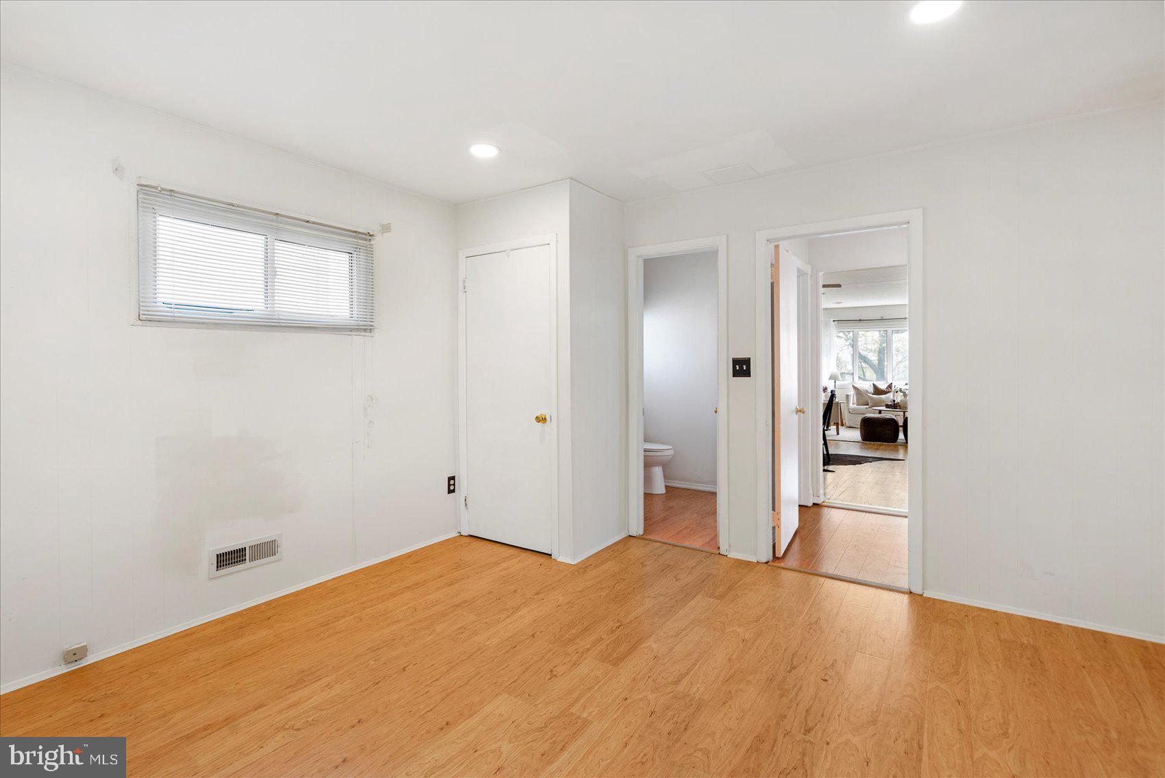 1828 Wycliffe Road Baltimore, MD 21234 - Photo 16 of 41 a bedroom with a bed and wooden floor