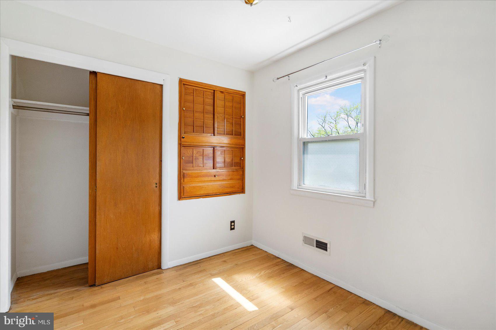 1828 Wycliffe Road Baltimore, MD 21234 - Photo 19 of 41 a view of an empty room with wooden floor and a window