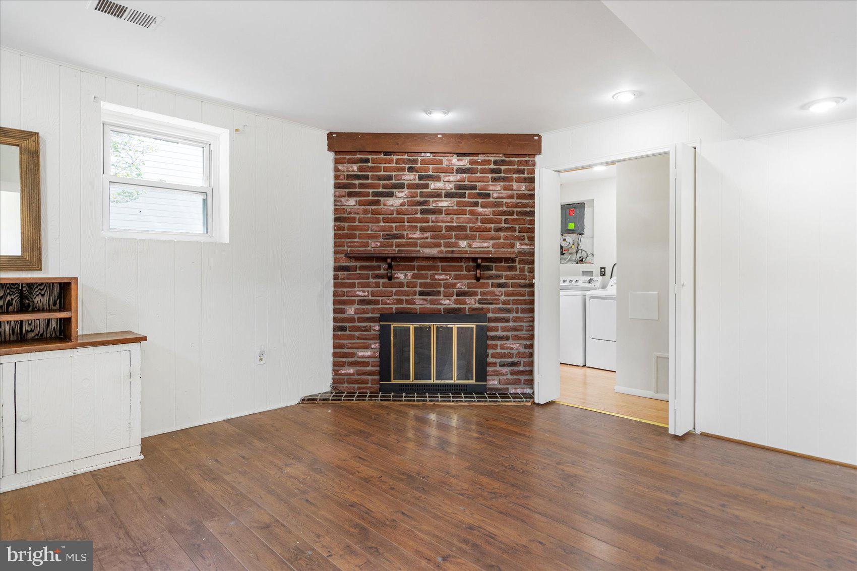 1828 Wycliffe Road Baltimore, MD 21234 - Photo 30 of 41 an empty room with wooden floor and windows