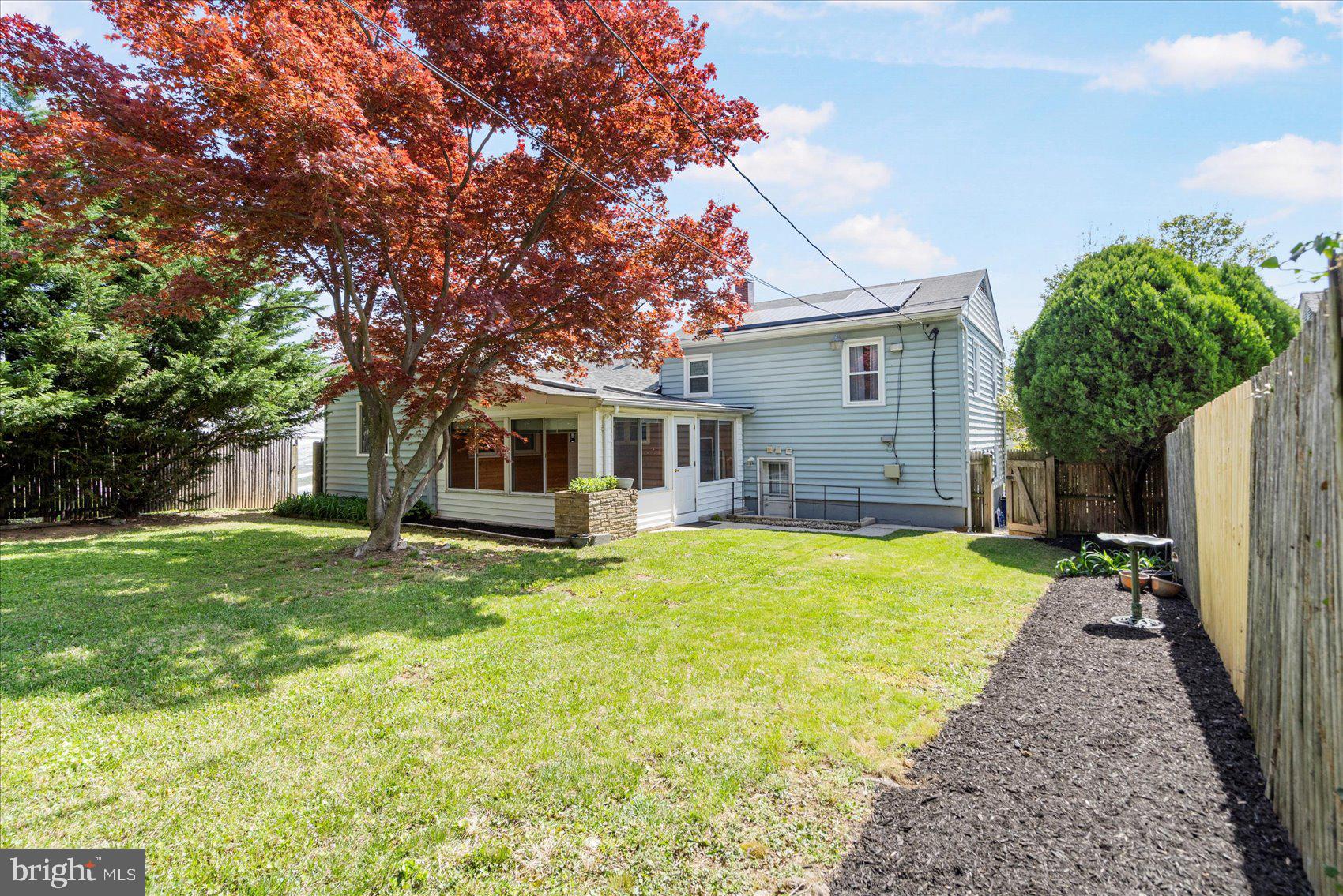 1828 Wycliffe Road Baltimore, MD 21234 - Photo 37 of 41 a view of a yard in front of a house with plants and large tree