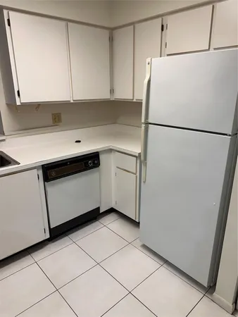 a utility room with cabinets washer and dryer