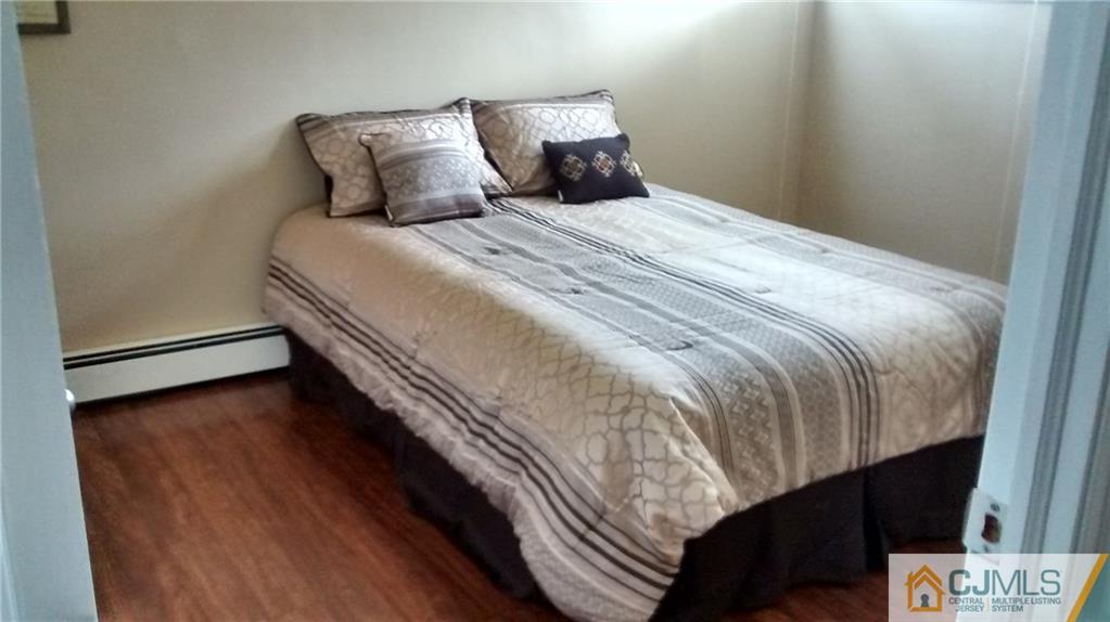 5 Ashley Road Edison, NJ 08817 - Photo 21 of 25 a bed sitting in a bedroom next to a window