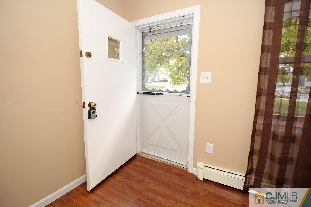 5 Ashley Road Edison, NJ 08817 - Photo 5 of 25 an empty room with wooden floor and a window
