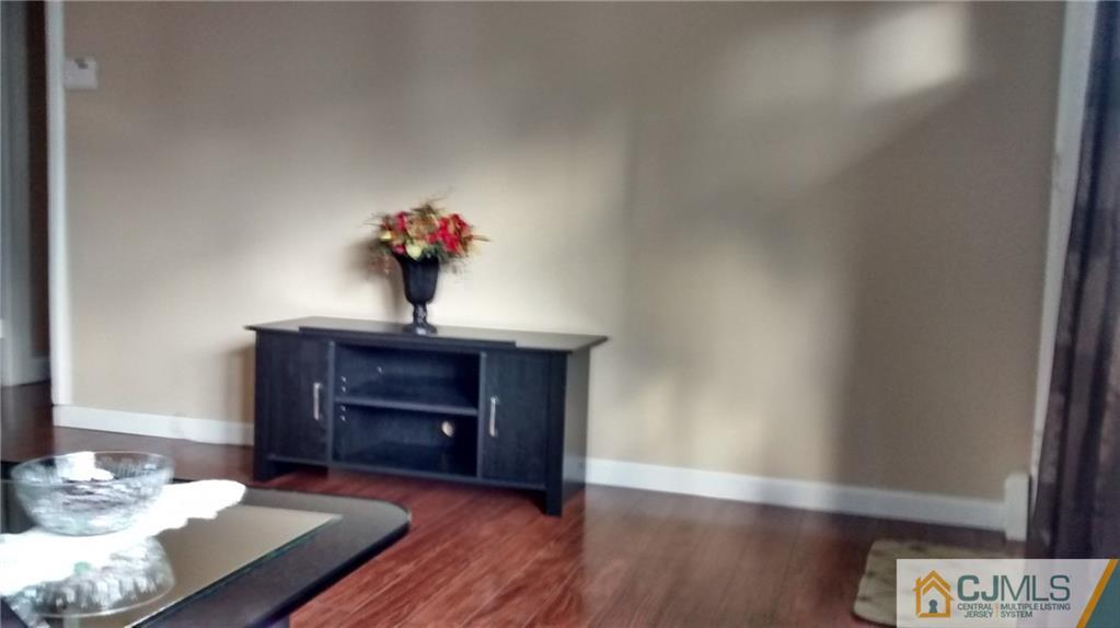 5 Ashley Road Edison, NJ 08817 - Photo 8 of 25 a living room with furniture and a fireplace