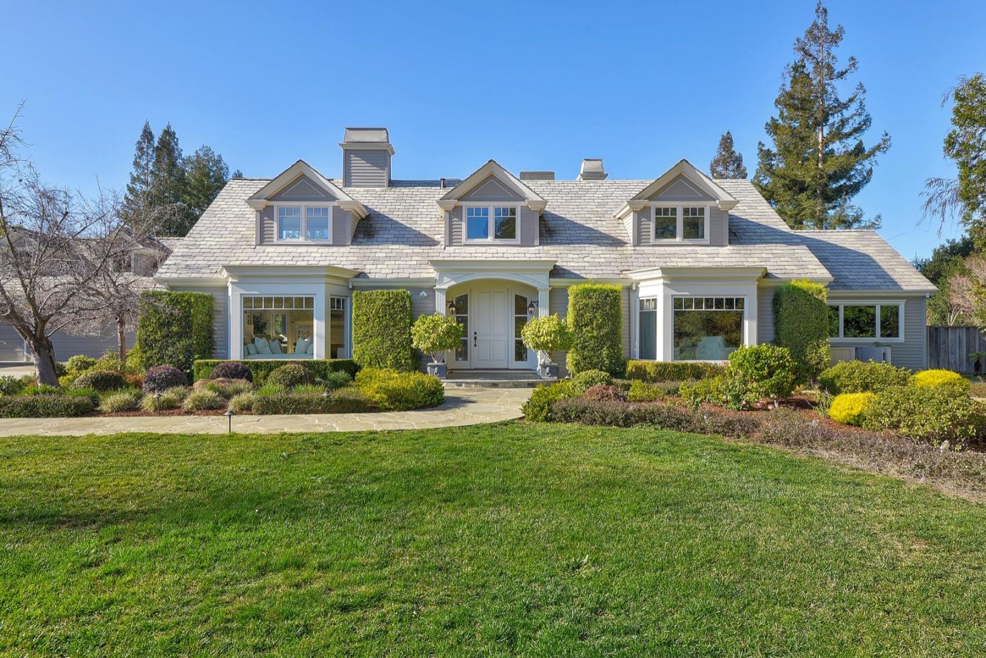 a front view of a house with a garden and porch