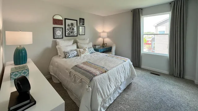 a bedroom with a bed and a window