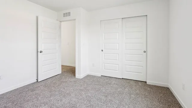 an empty room with closet area
