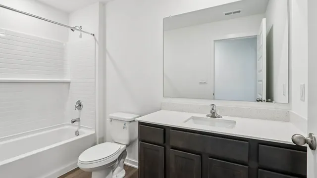 a bathroom with a sink toilet tub and shower