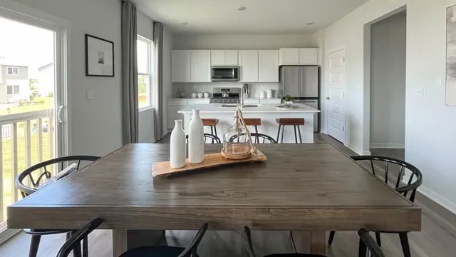 a view of kitchen with dining table and chairs