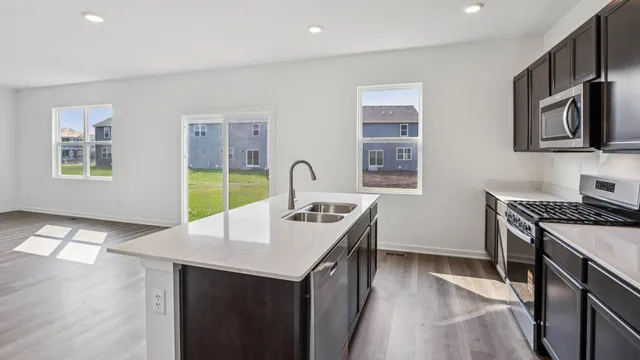 a kitchen that has a sink and a stove