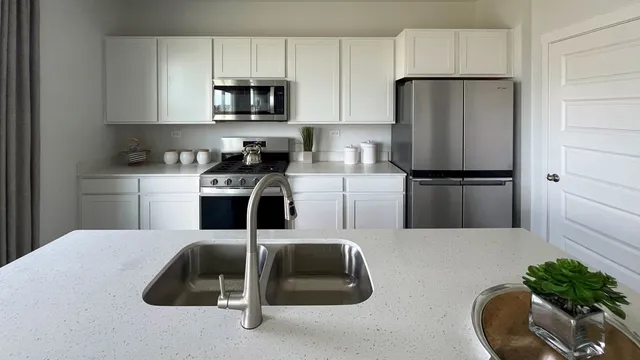 a kitchen with cabinets and stainless steel appliances