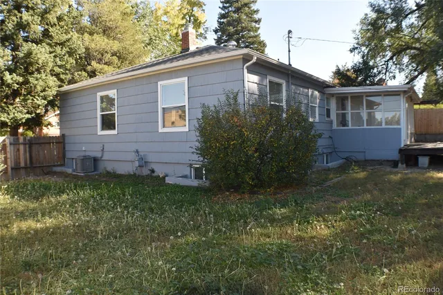 a view of house with backyard and garden