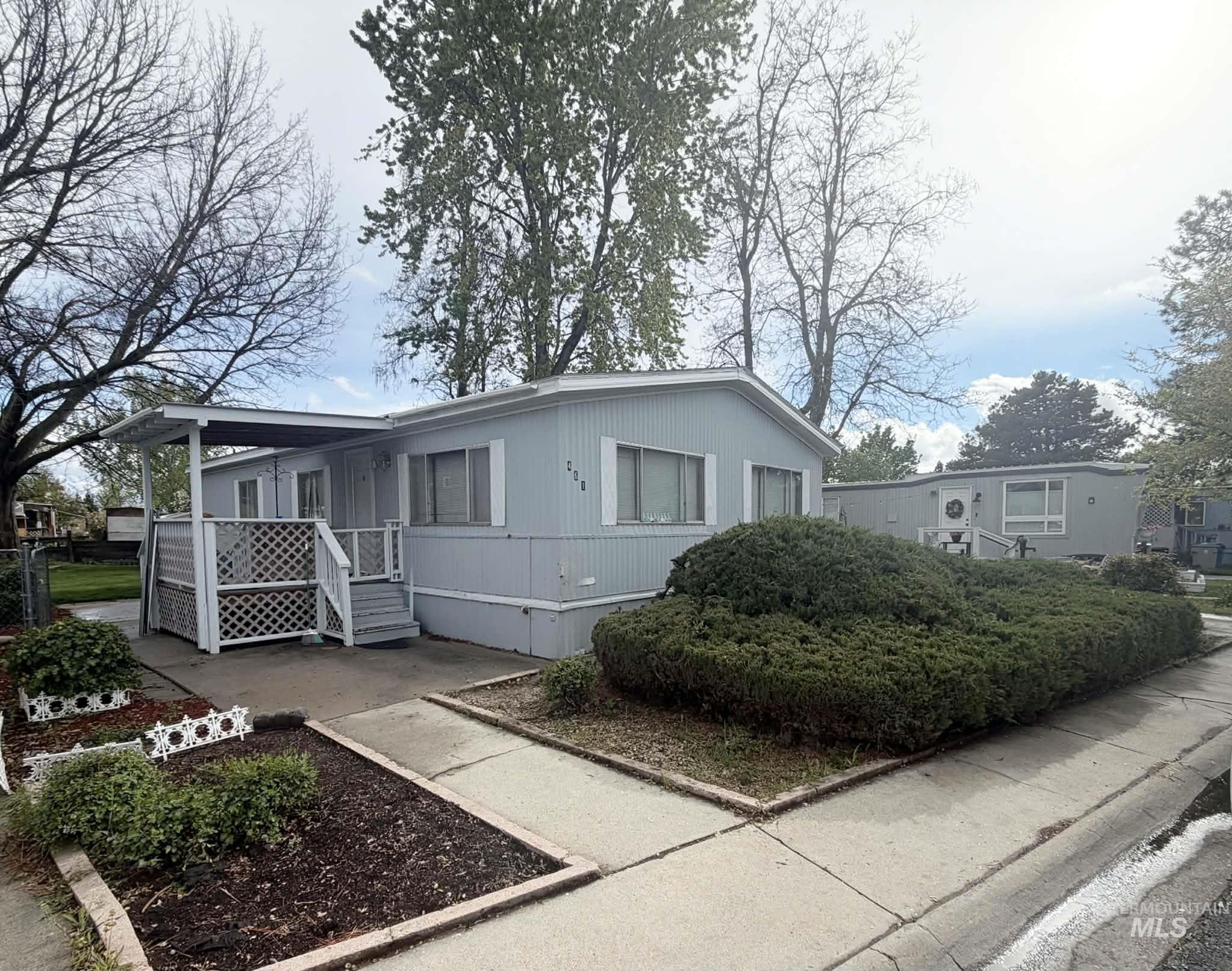461 Greenleaf Street Boise, ID 83713 - Photo 2 of 19 Light blue siding exterior with white trim accents and a covered front porch featuring lattice detailing