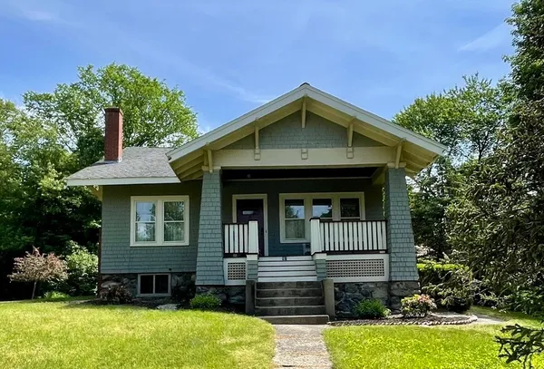 a front view of a house with garden