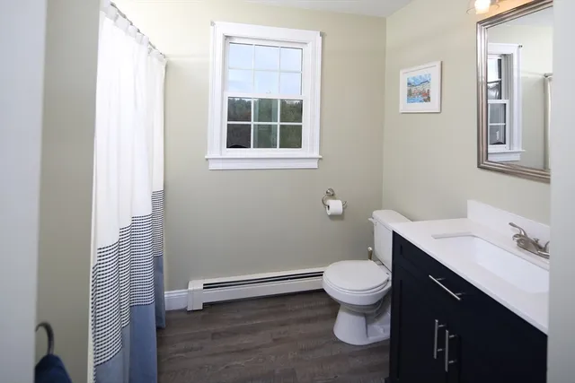 a bedroom with furniture and a large window