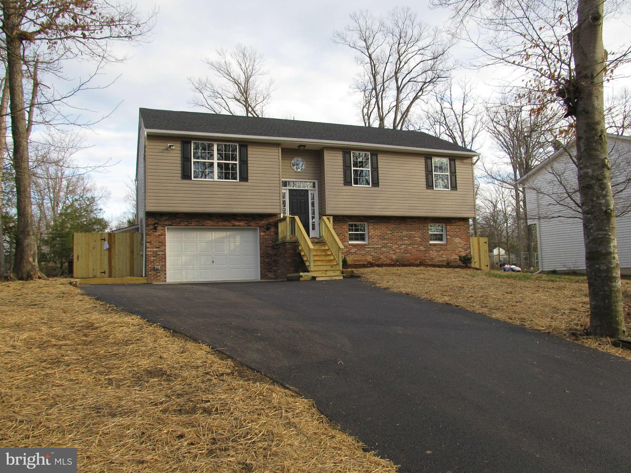 12554 Santa Rosa Road Lusby, MD 20657 - Photo 6 of 23 a view of a house with a yard and garage