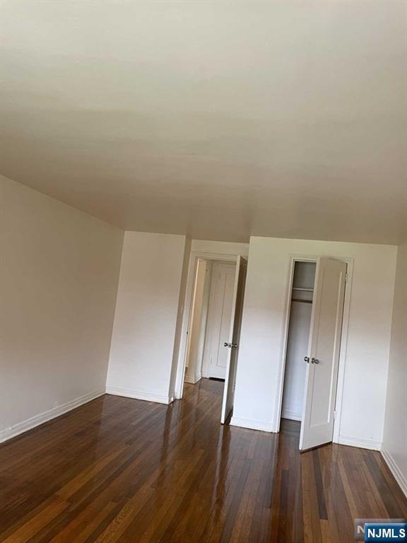 29 West Passaic Street Maywood, NJ 07607 - Photo 12 of 28 an empty room with wooden floor and hallway