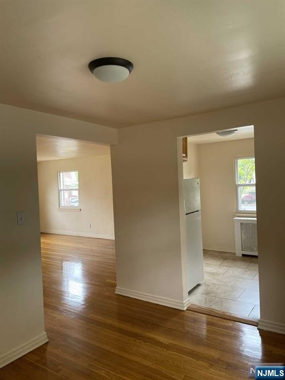 29 West Passaic Street Maywood, NJ 07607 - Photo 14 of 28 an empty room with wooden floor and a window