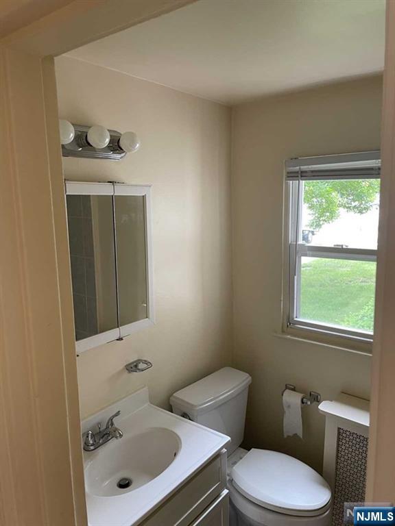 29 West Passaic Street Maywood, NJ 07607 - Photo 16 of 28 a bathroom with a sink toilet and mirror