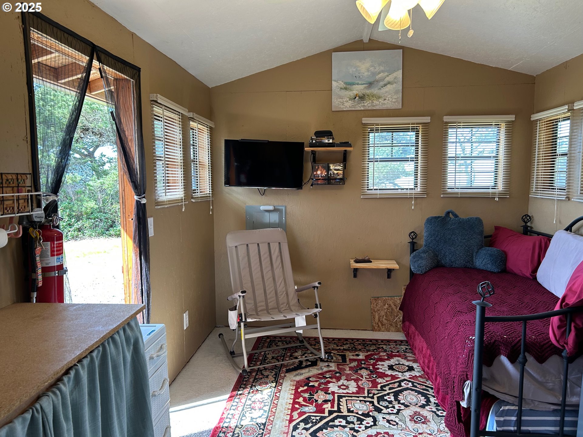 88433 2nd Avenue Florence, OR 97439 - Photo 12 of 25 a living room with furniture a flat screen tv and a window