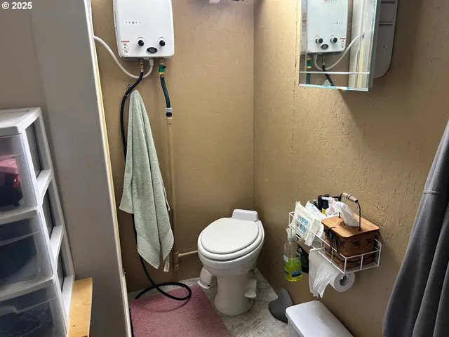 a bathroom with a toilet and a mirror