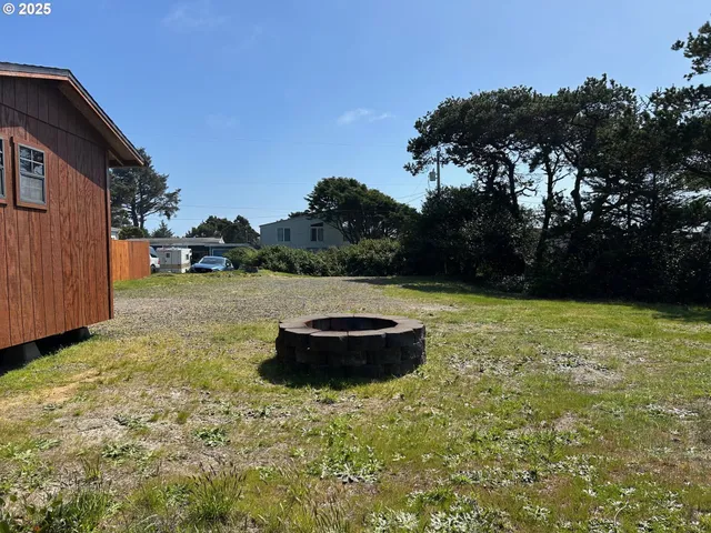 a view of a backyard with plants and tree