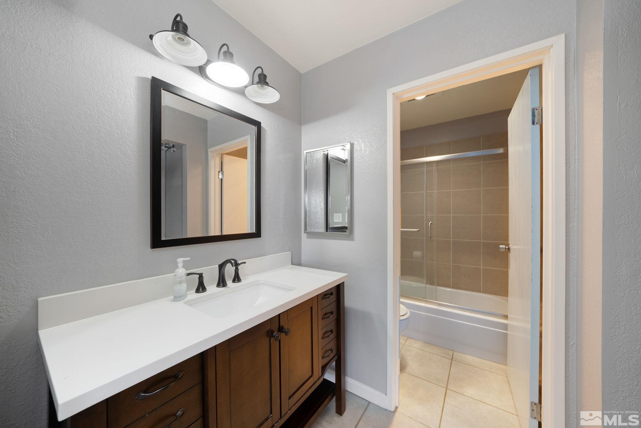 2450 Lymbery Street, Unit 227 Reno, NV 89509 - Photo 8 of 14 a bathroom with a sink vanity and a mirror