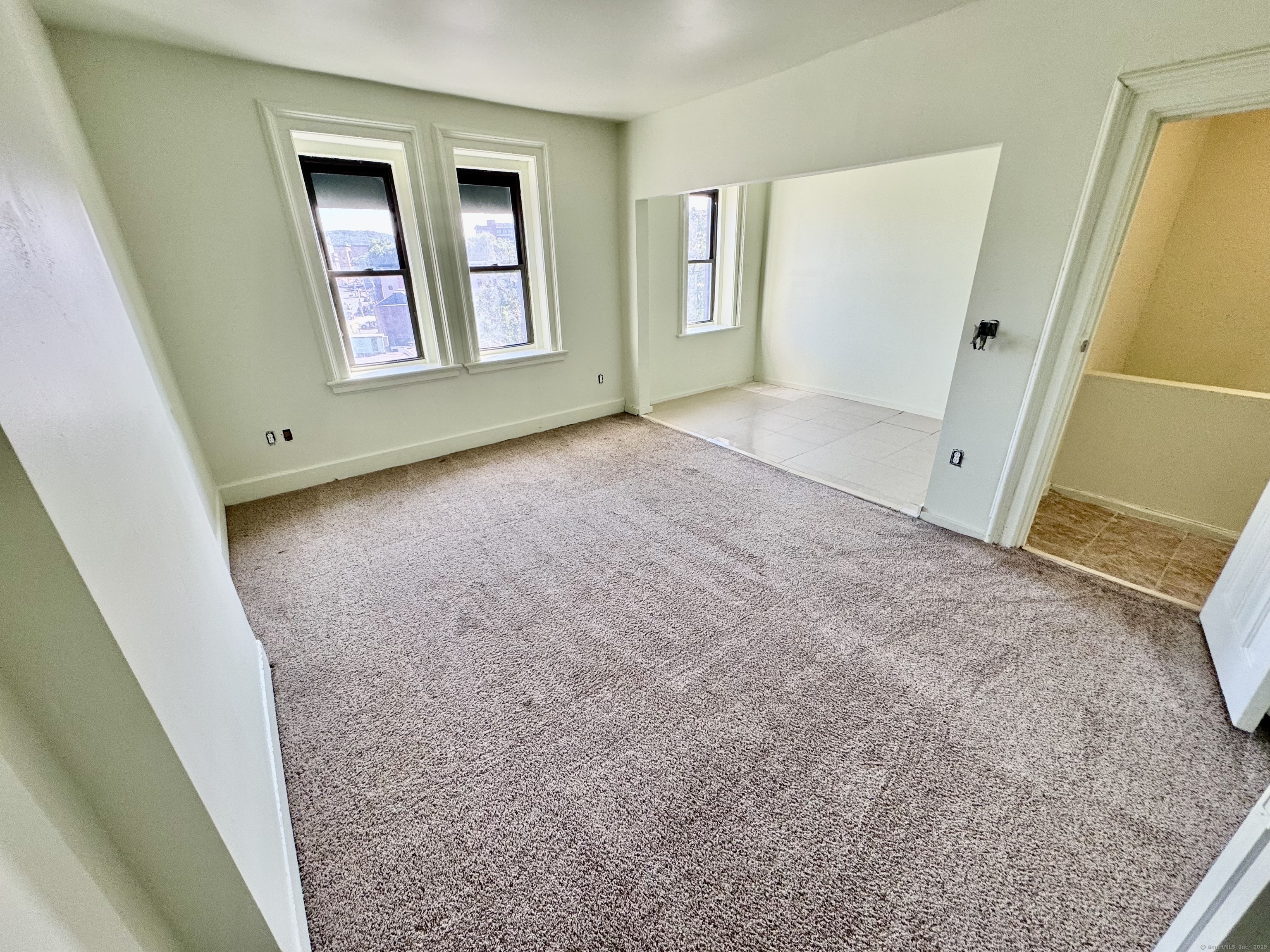 491 Meadow Street Waterbury, CT 06702 - Photo 12 of 12 an empty room with windows and closet