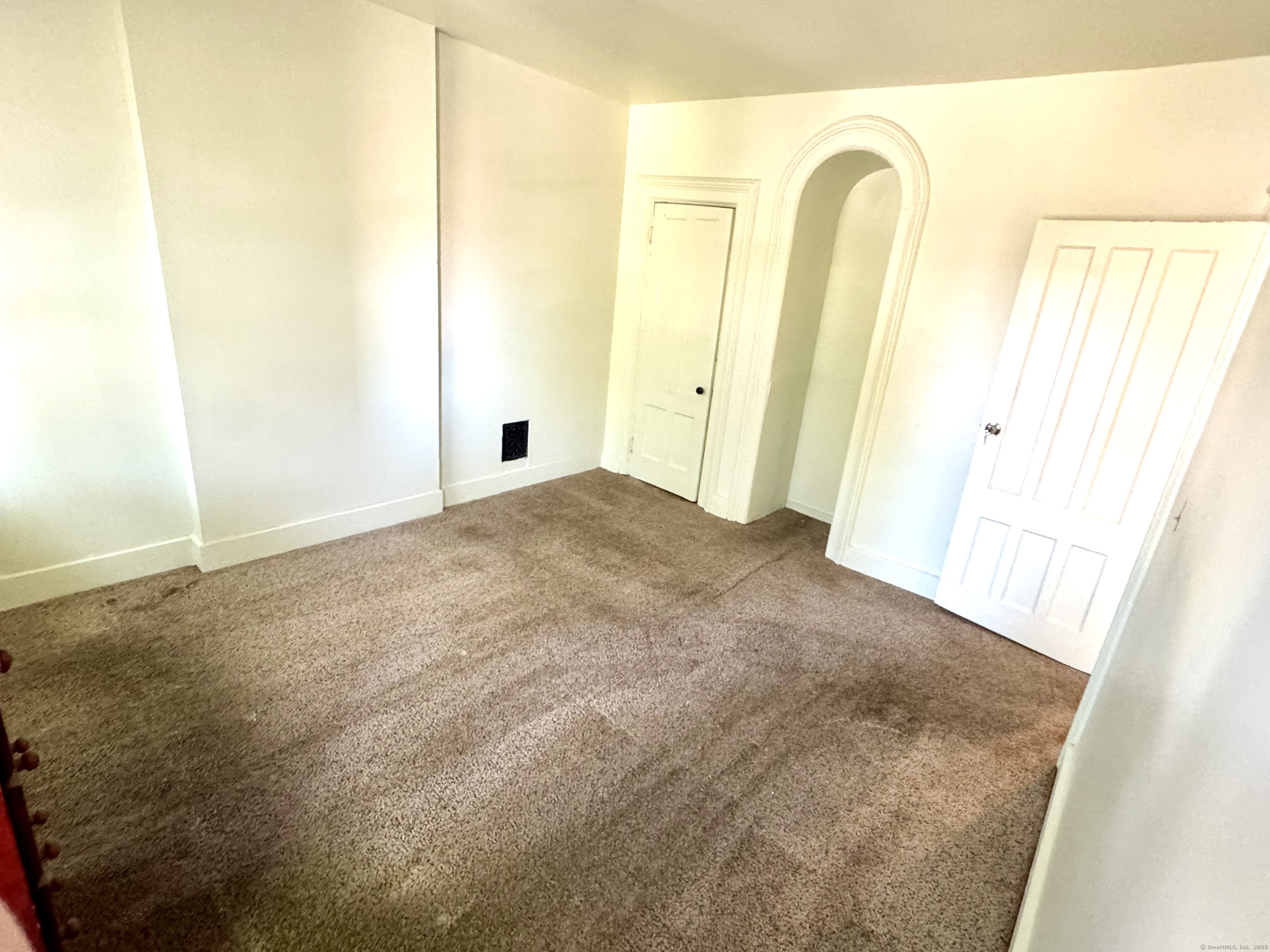 491 Meadow Street Waterbury, CT 06702 - Photo 6 of 12 a view of an empty room with windows