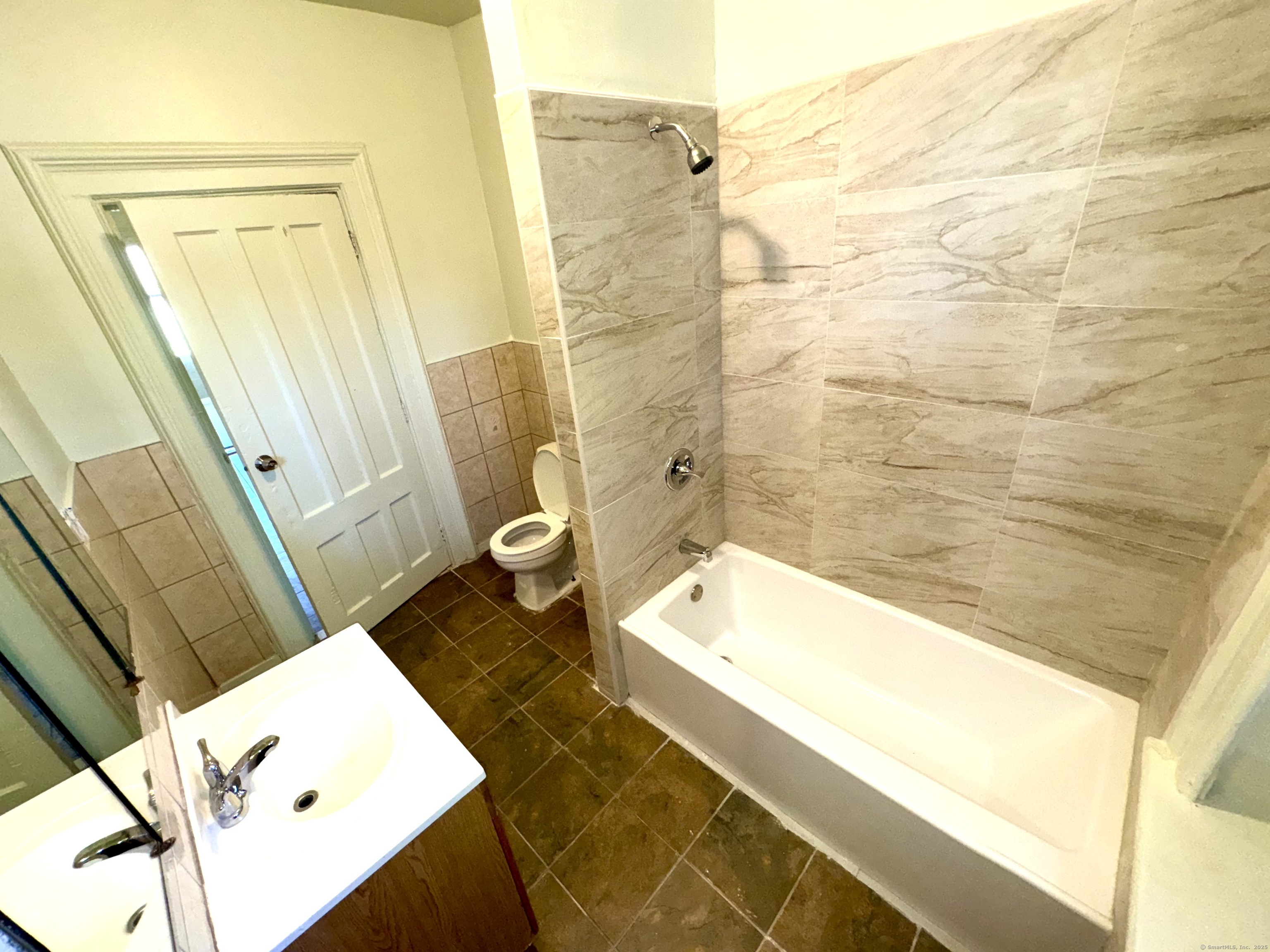 491 Meadow Street Waterbury, CT 06702 - Photo 9 of 12 a bathroom with a tub a sink and a shower