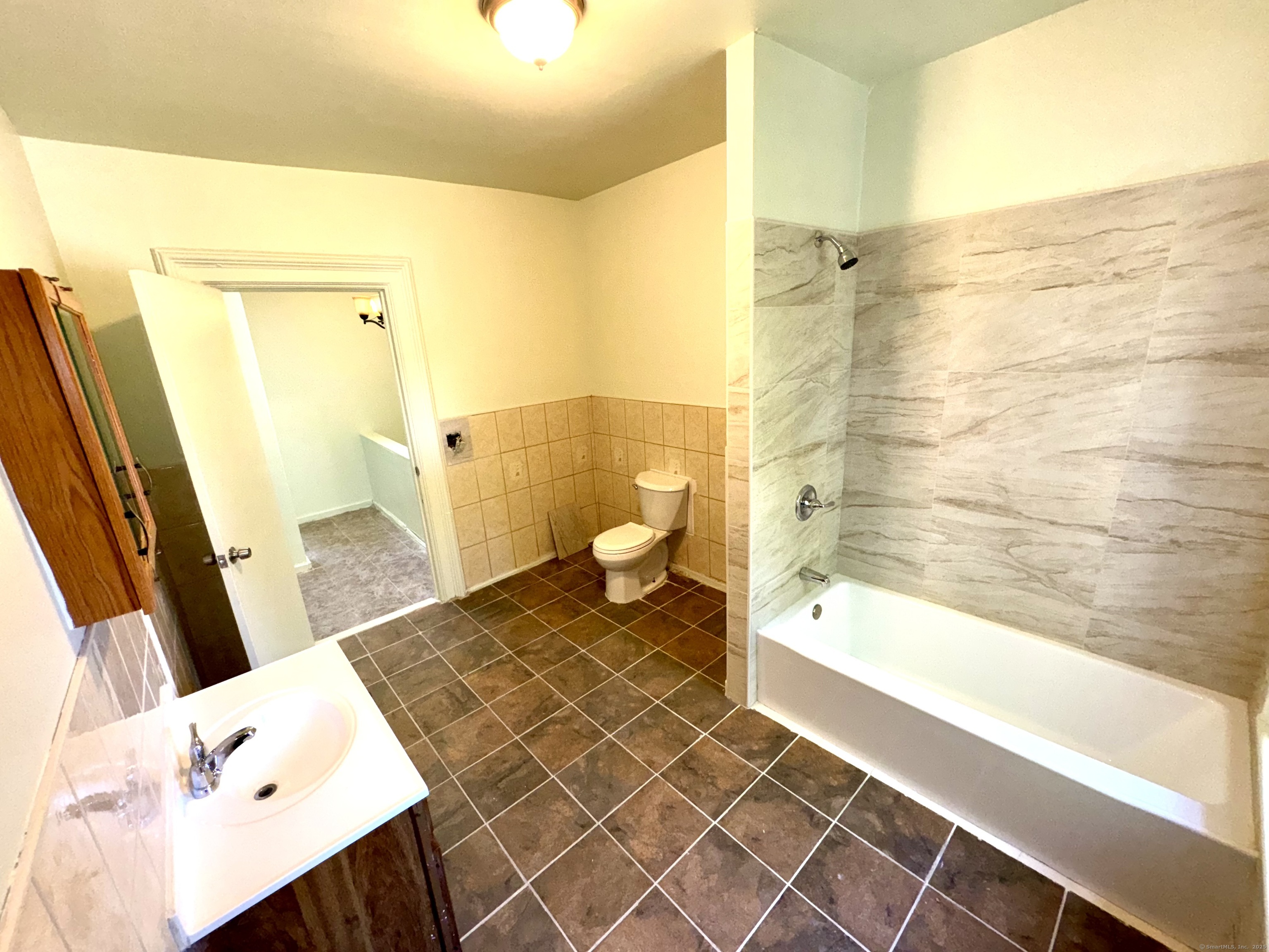 491 Meadow Street Waterbury, CT 06702 - Photo 10 of 12 a bathroom with a sink a toilet and shower