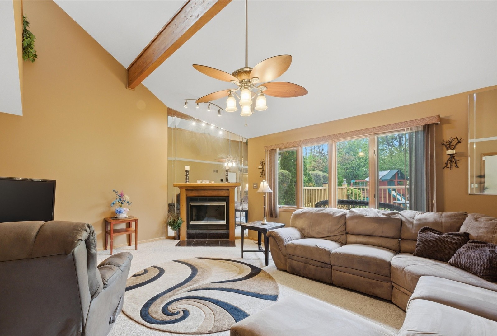 3552 Fairway Drive Crete, IL 60417 - Photo 9 of 27 a living room with furniture a fireplace and a flat screen tv