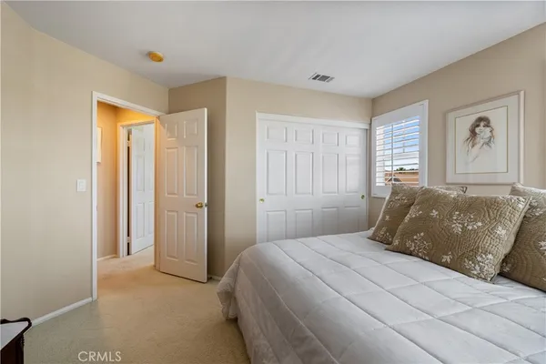 a bedroom with a large bed and a window