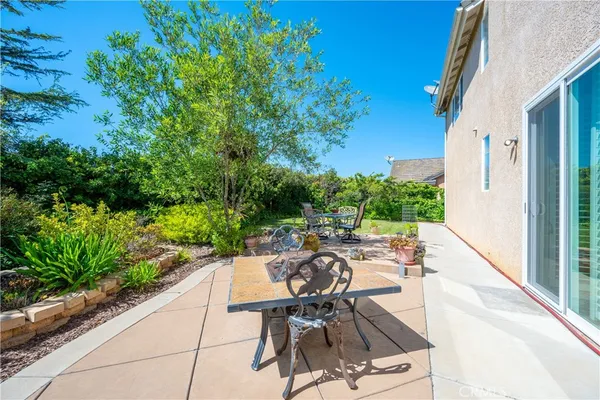 a view of a patio with table and chairs and potted plants
