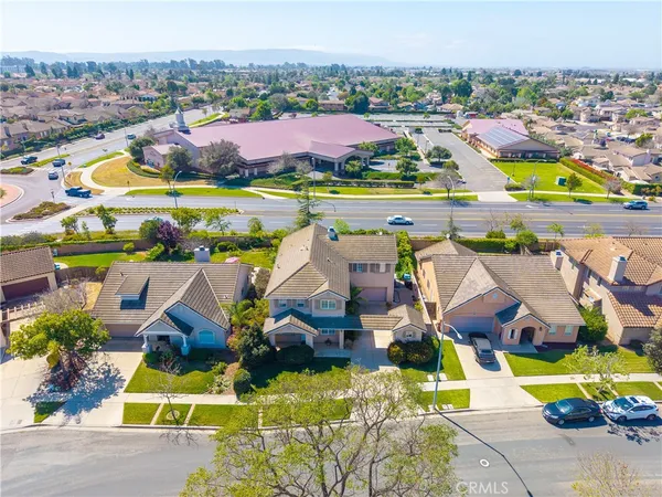 an aerial view of residential houses with outdoor space and lake view