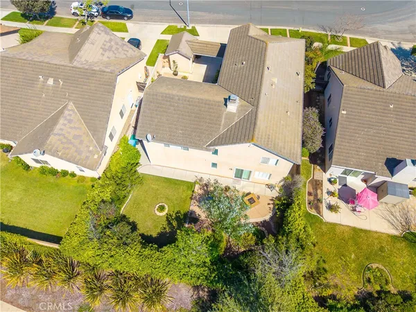 an aerial view of residential houses with outdoor space and swimming pool
