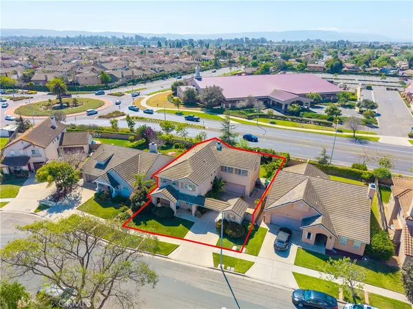 an aerial view of residential houses with outdoor space and city view
