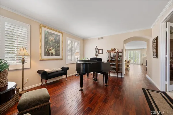 a view of a livingroom with furniture window and wooden floor